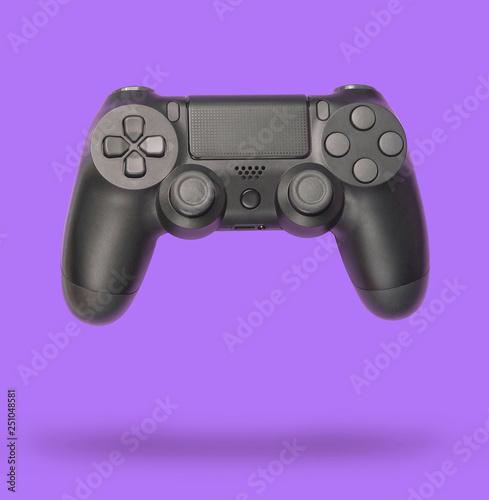 Gamepads on purple paper background. Top view. Minimalism