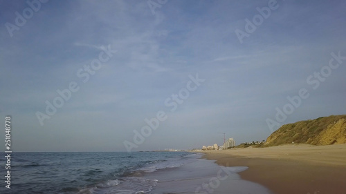 Sliding by the coastline of empty off season mediterrian beach