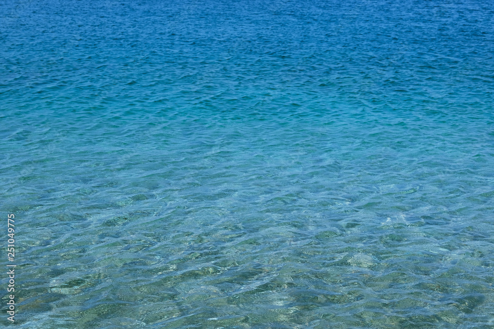 Obraz premium Blue transparent sea water texture. Bright ocean water background. Summer holiday concept.