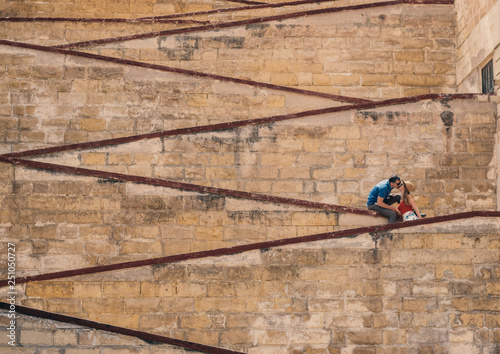 Man kissing woman on the city walls