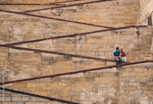Man kissing woman on the city walls © el_caro