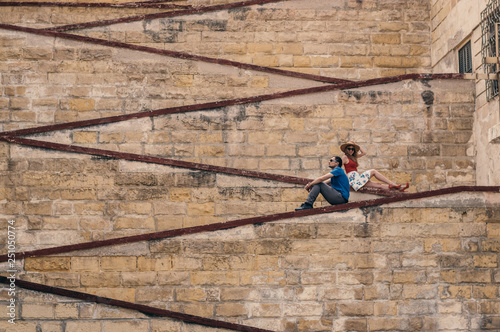 Man with woman sitting on the city walls © el_caro