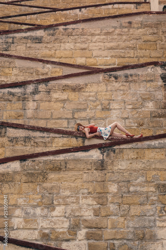 Young girl laying on the city walls © el_caro