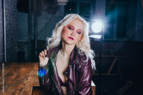 Portrait of sexy blonde girl in purple leather jacket