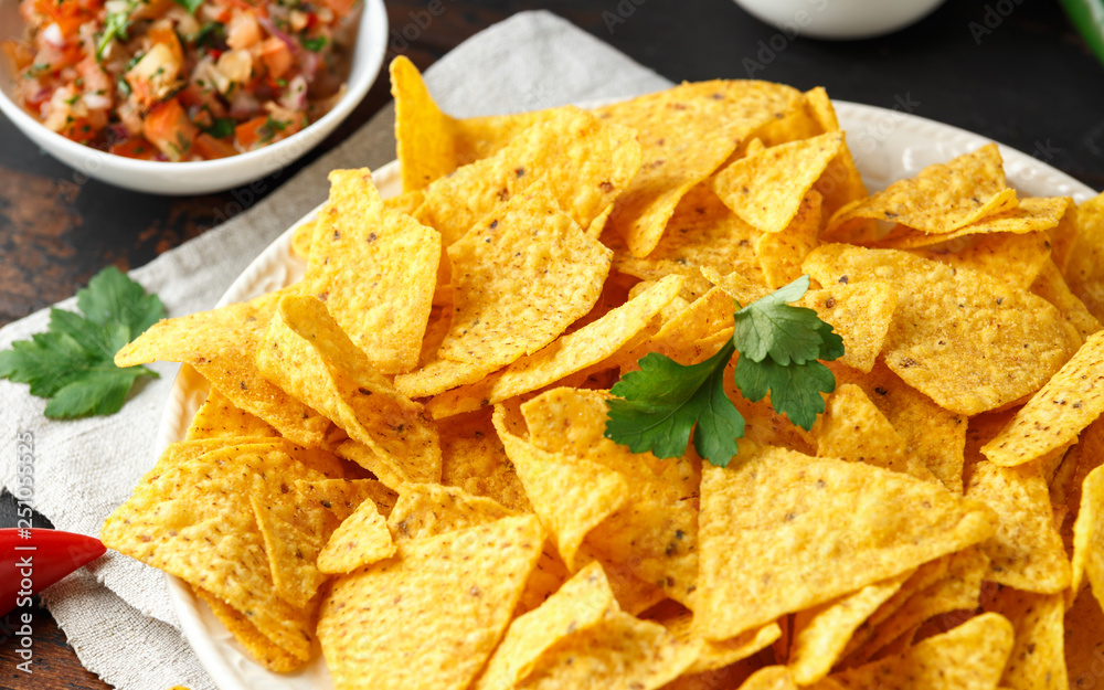 Tortilla nachos chips with cheese sauce, guacamole and tomatoes salsa dip. lime. chilli pepper. Tortilla nachos chips with cheese sauce, guacamole and tomatoes salsa dip. lime. chilli pepper.