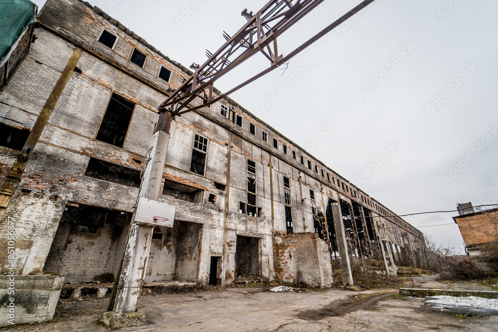 Destroyed abandoned factory after the war, broken glass, destruction, frightening industrial composition