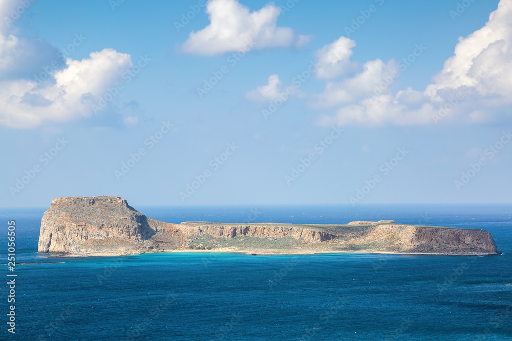 Mysterious Balos bay, island Crete, Greece. In the azure sea there are mountains edged with the water. Sky with clouds. Waves. Landscape in sunny day.