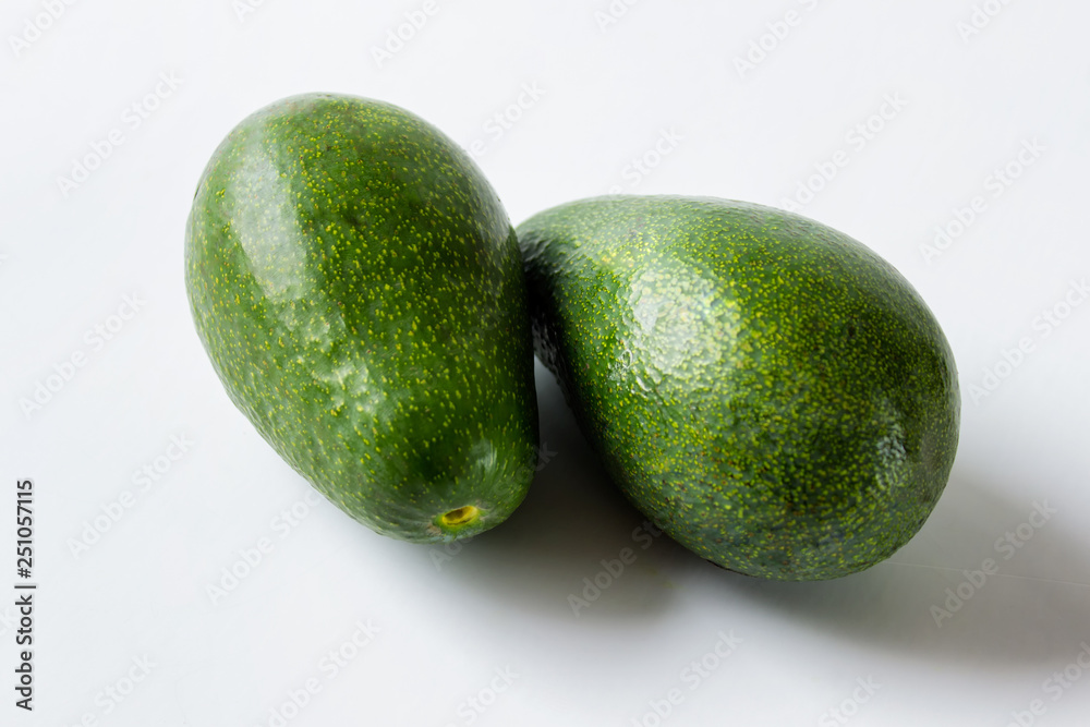 Two large avocados on white background. Two large avocados on white background.
