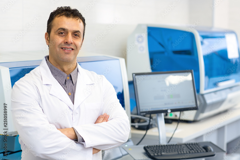 Mature Hispanic scientist working at his laboratory
