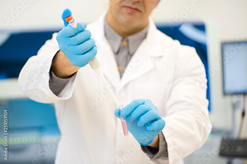 Mature Hispanic scientist working at his laboratory