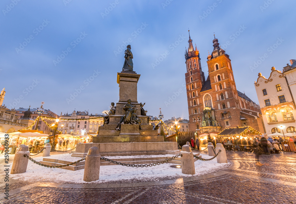 Krakow, main square winter evening, christmas fairs, Mickiewicz statue and St Mary church