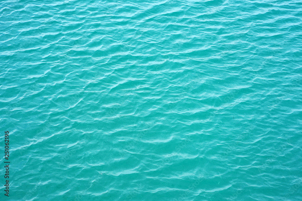 Blue rippled water as abstract background. Tranquil surface texture of the sea. Water ripples of a lake. Blue sea water in calm. Blue rippled water as abstract background. Tranquil surface texture of the sea. Water ripples of a lake. Blue sea water in calm.