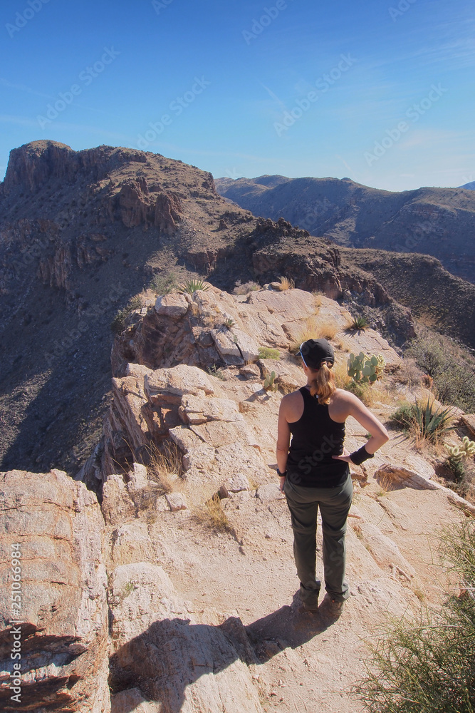 Woman enjoying expansive views at the end of the Blackett's Ridge Trail in the Santa Catalina Mountains near Tucson, Arizona. Woman enjoying expansive views at the end of the Blackett's Ridge Trail in the Santa Catalina Mountains near Tucson, Arizona.