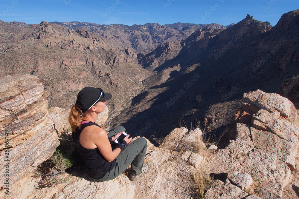 Woman enjoying expansive views at the end of the Blackett's Ridge Trail in the Santa Catalina Mountains near Tucson, Arizona.