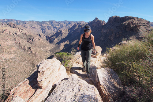 Woman enjoying expansive views at the end of the Blackett's Ridge Trail in the Santa Catalina Mountains near Tucson, Arizona.