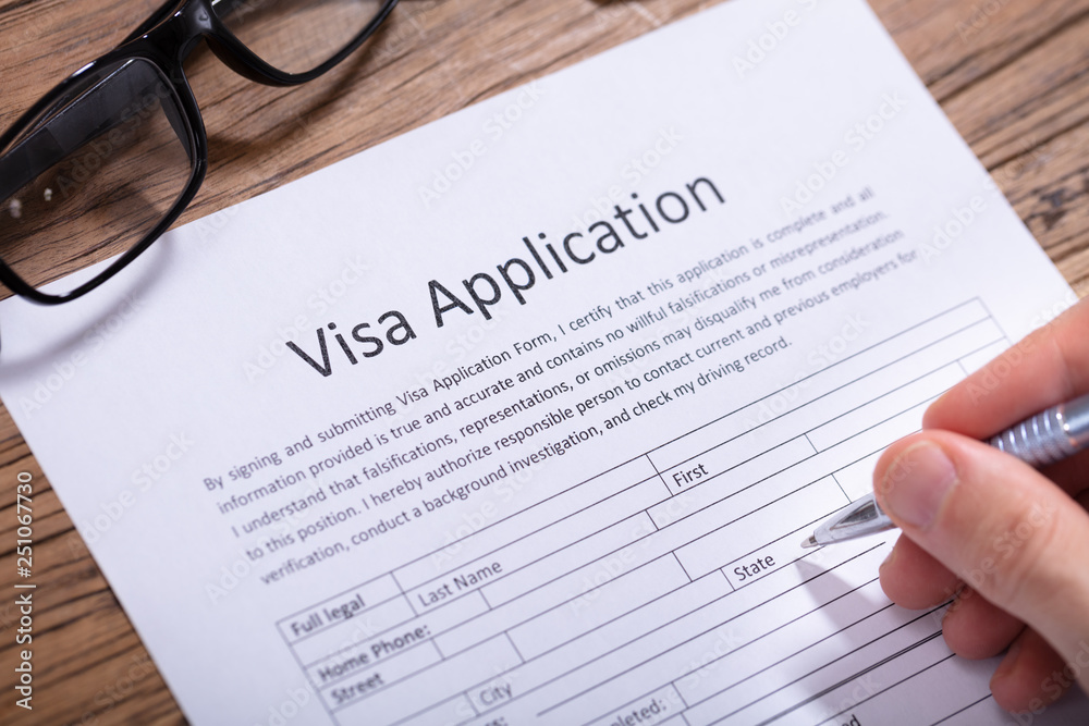 Man Filling Visa Application Form Man Filling Visa Application Form