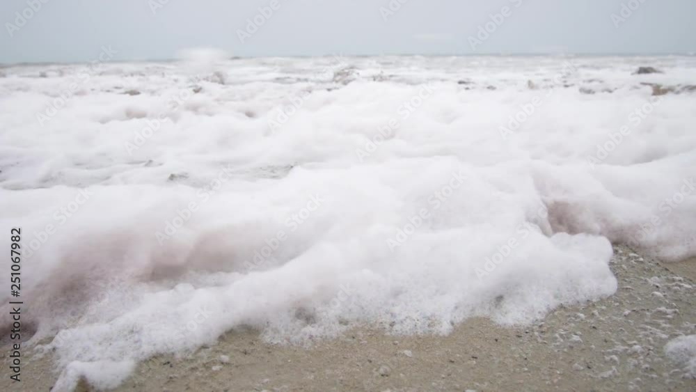 Foam blown by strong winds roaring at the shore of what is left of the dying Aral Sea, Uzbekistan Foam blown by strong winds roaring at the shore of what is left of the dying Aral Sea, Uzbekistan