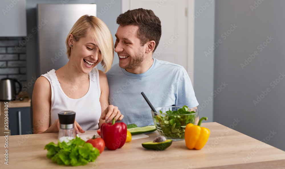 Romantic couple making healthy salad 