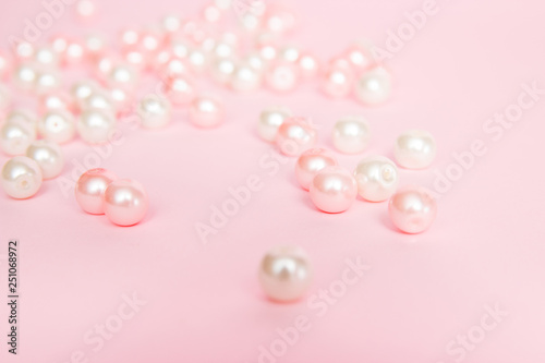 Pink beads on pink background close up