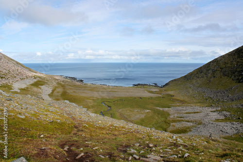 Hiking to Knivskjellodden peninsula with blue Atlantic Ocean in the backround. Mageroya Island, Finnmark, Norway
