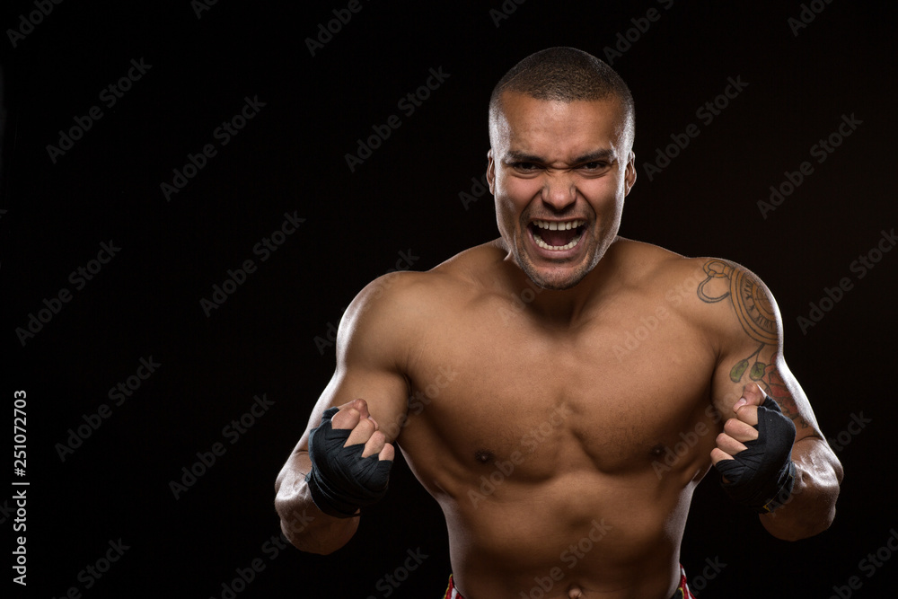 Fototapeta premium Muscular shirtless male fighter on black background