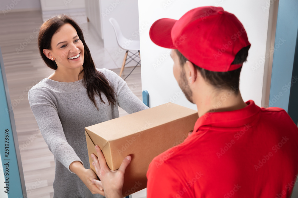Delivery Man Giving Box To Young Woman Delivery Man Giving Box To Young Woman