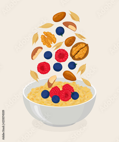 Porridge oats in bowl with bananas, berries, strawberry, nuts and cereals isolated on white background. Healthy breakfast