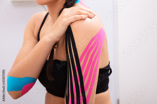 Woman Having Physio Therapy Tape On Her Arms