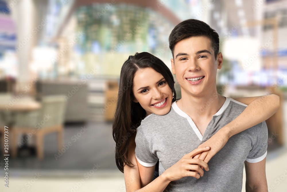 Happy young beautiful couple on blue background