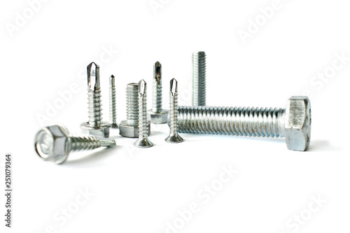 Closeup of different types of fasteners isolated on white. Isolated fasteners. Connecting material on white background