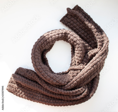 Brown knitted scarf on white background