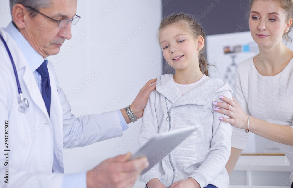 Fototapeta premium Little girl with her mother at a doctor on consultation