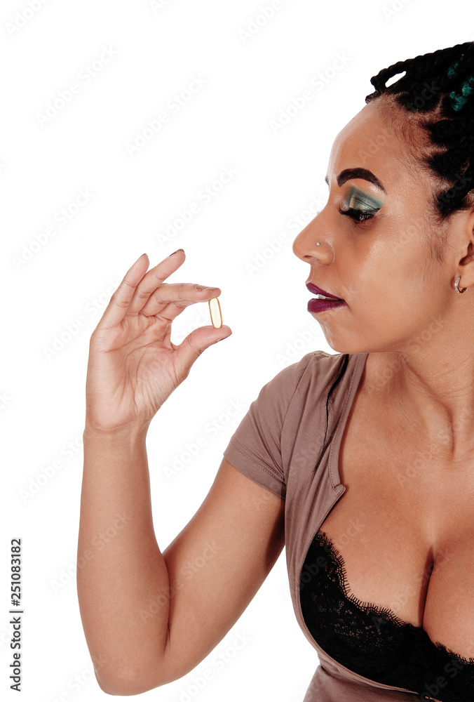Naklejka premium Woman going to swallowing a vitamin pill