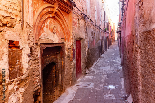 Colorful ancient old and narrow street in medina of Marrakech, Morocco, Africa © pszabo