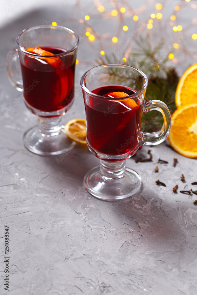 mulled red wine with spices and orange on dark background. warming drink mulled red wine with spices and orange on dark background. warming drink
