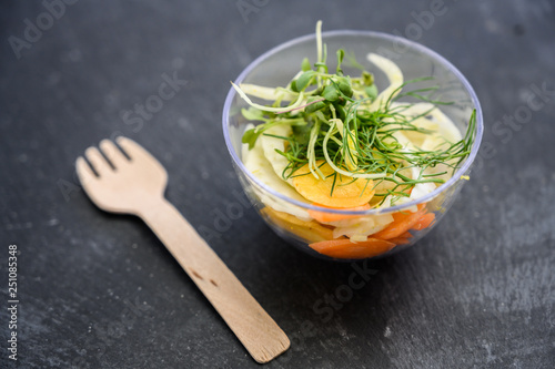 salad in a tiny bowl with wood fork 