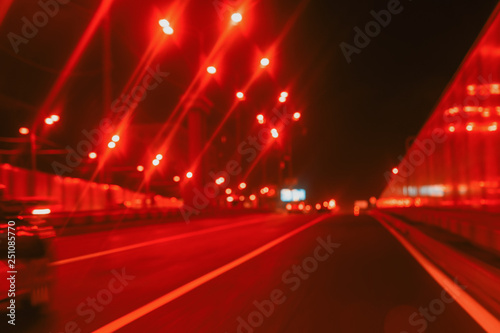 Driving on the city tunnel at night, moving cars with urban street illumination, motion blur. Concept of modern lifestyle