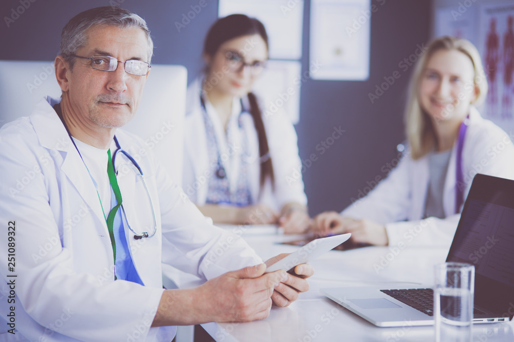Doctor and patient discussing something while sitting at the table . Medicine and health care concept Doctor and patient discussing something while sitting at the table . Medicine and health care concept