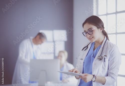 Female doctor using tablet computer in hospital lobby