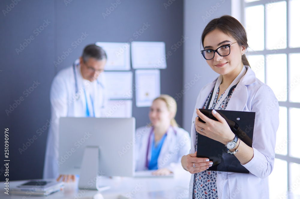 Woman doctor standing with stethoscope at hospital Woman doctor standing with stethoscope at hospital