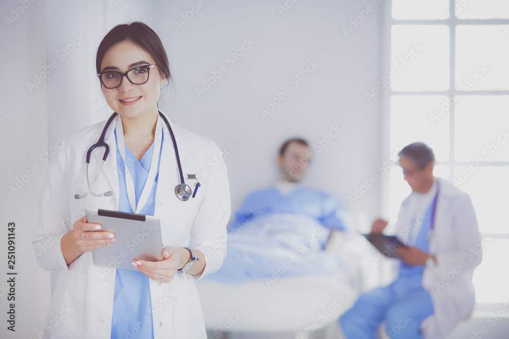 Female doctor using tablet computer in hospital lobby Female doctor using tablet computer in hospital lobby