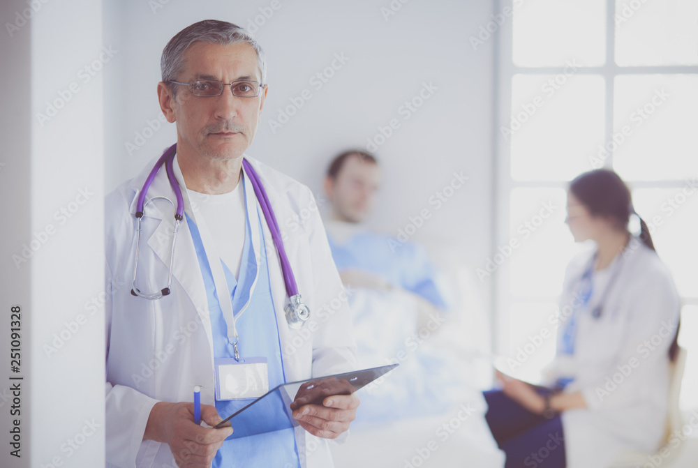 Doctor holding folder in front of a patient and a doctor Doctor holding folder in front of a patient and a doctor