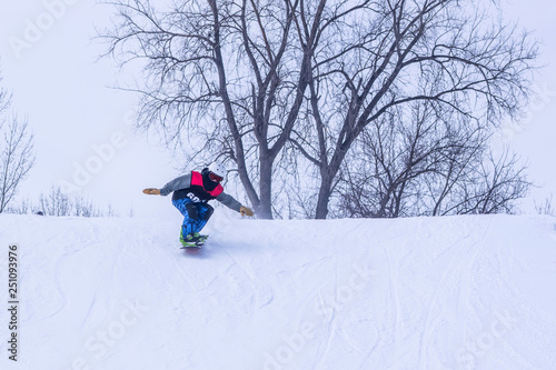 People are enjoying downhill skiing and snowboarding 