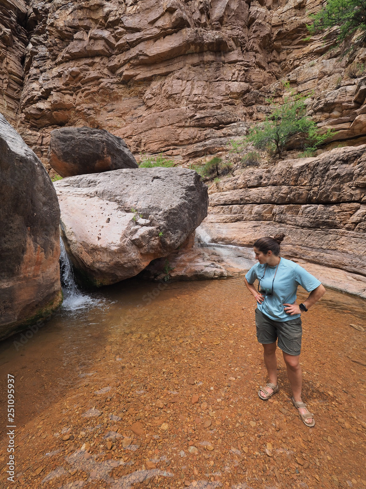 Young woman enjoys some downtime in Hermit Creek during a multi-day backpacking expedition on the Hermit Loop in Grand Canyon National Park, Arizona.