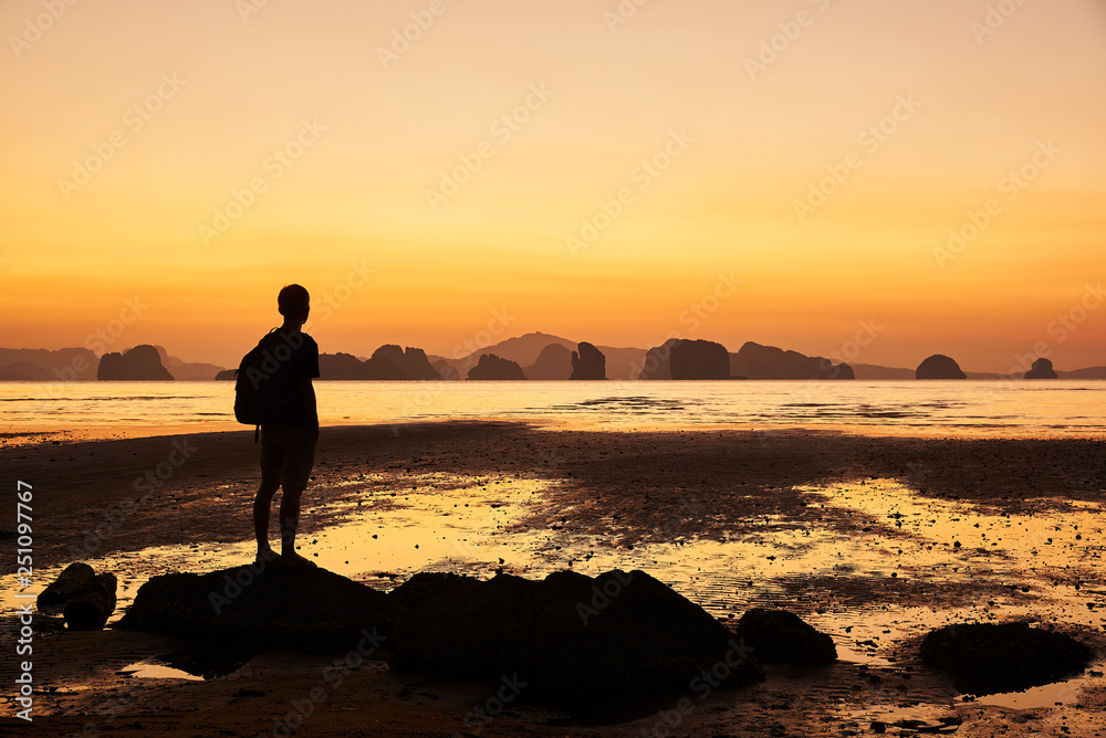 A man looking at beautiful sunrise in the sea