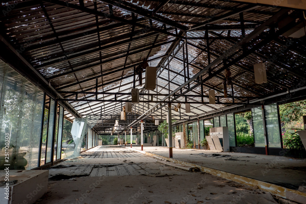 The abandoned and frightened building with broken door windows ceiling and roof in the day light. 