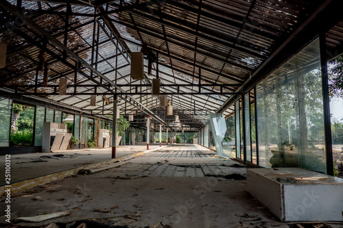 The abandoned and frightened building with broken door windows ceiling and roof in the day light. 