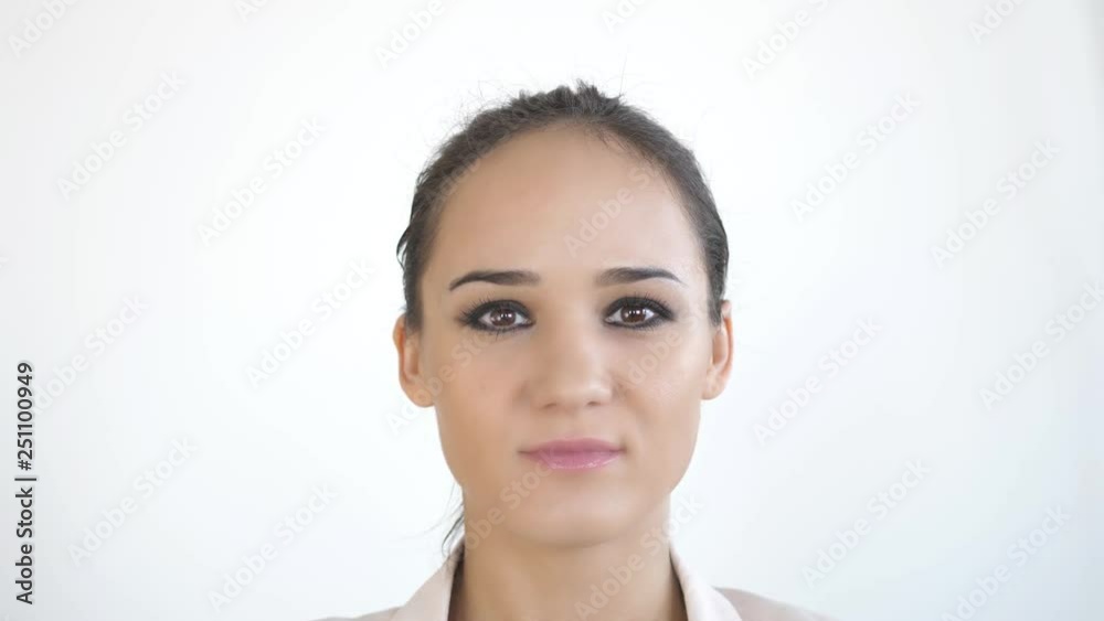 Close up portrait of young caucasian woman on a white background. slow motion. 3840x2160 Close up portrait of young caucasian woman on a white background. slow motion. 3840x2160