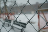 Chain link fence covered in snow