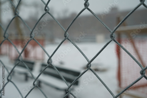 Chain link fence covered in snow